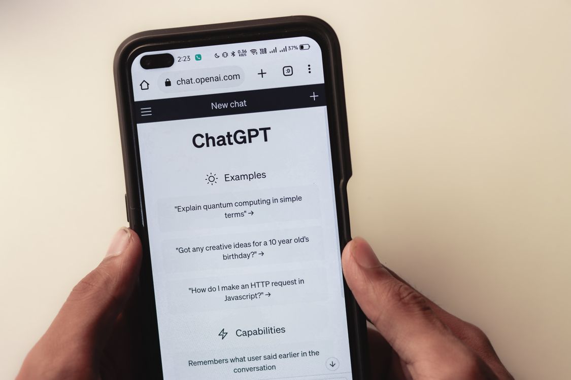 Close-up of hands holding a smartphone displaying the ChatGPT interface, representing AI search visibility