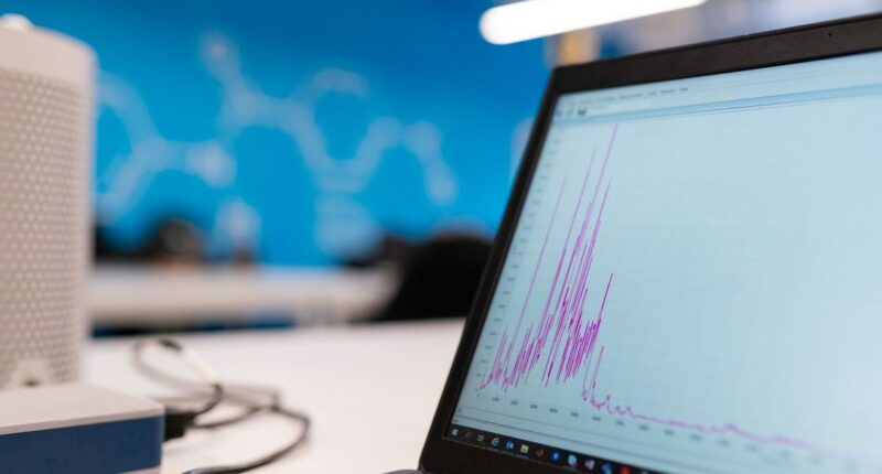 Laptop displaying a data analytics graph, representing schema markup's impact on search performance