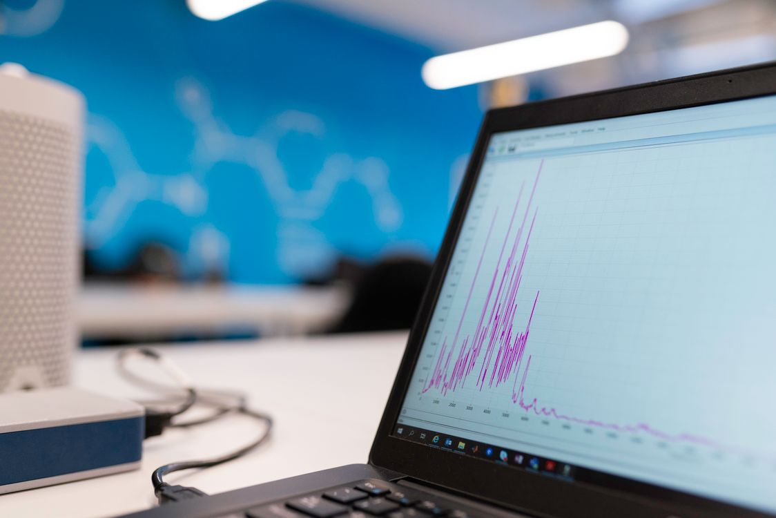 Laptop displaying a data analytics graph, representing schema markup's impact on search performance