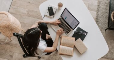 Freelancer typing on a laptop at a home desk, representing blog writing and publishing