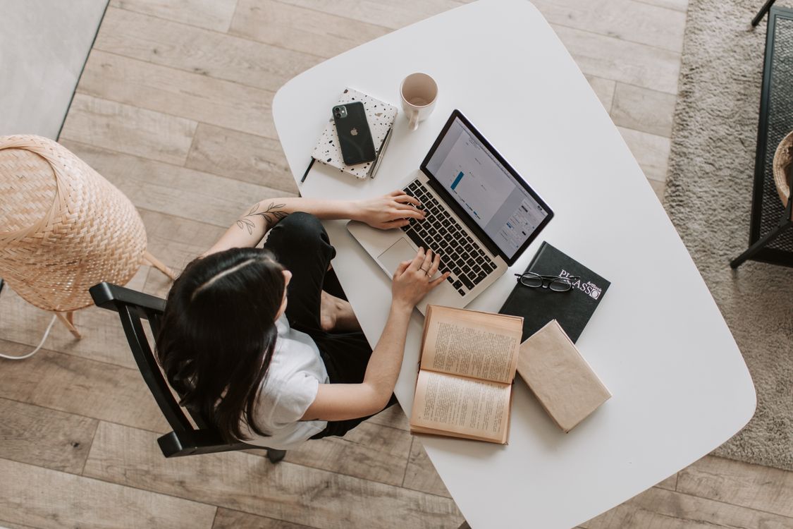 Freelancer typing on a laptop at a home desk, representing blog writing and publishing