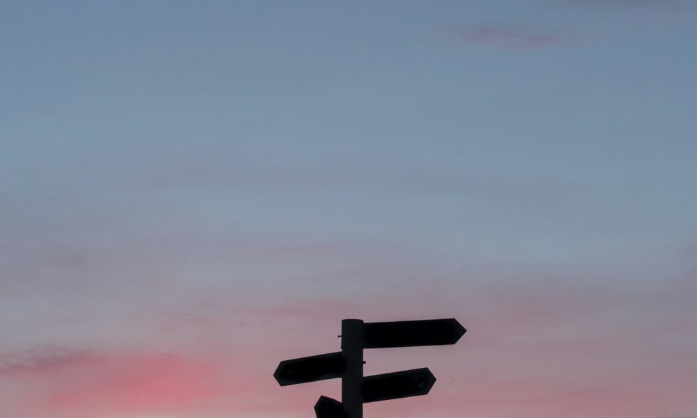 Silhouette of a road sign at golden hour, symbolizing a career pivot later in life