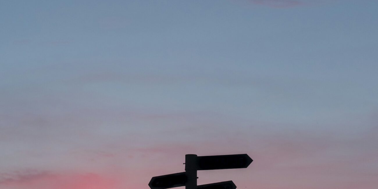 Silhouette of a road sign at golden hour, symbolizing a career pivot later in life