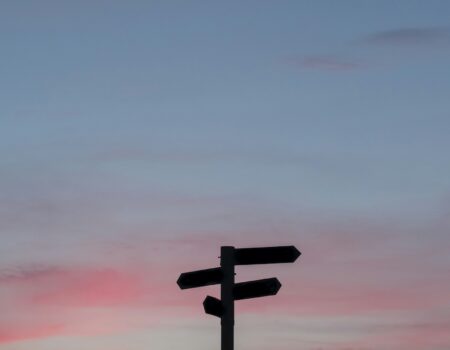 Silhouette of a road sign at golden hour, symbolizing a career pivot later in life