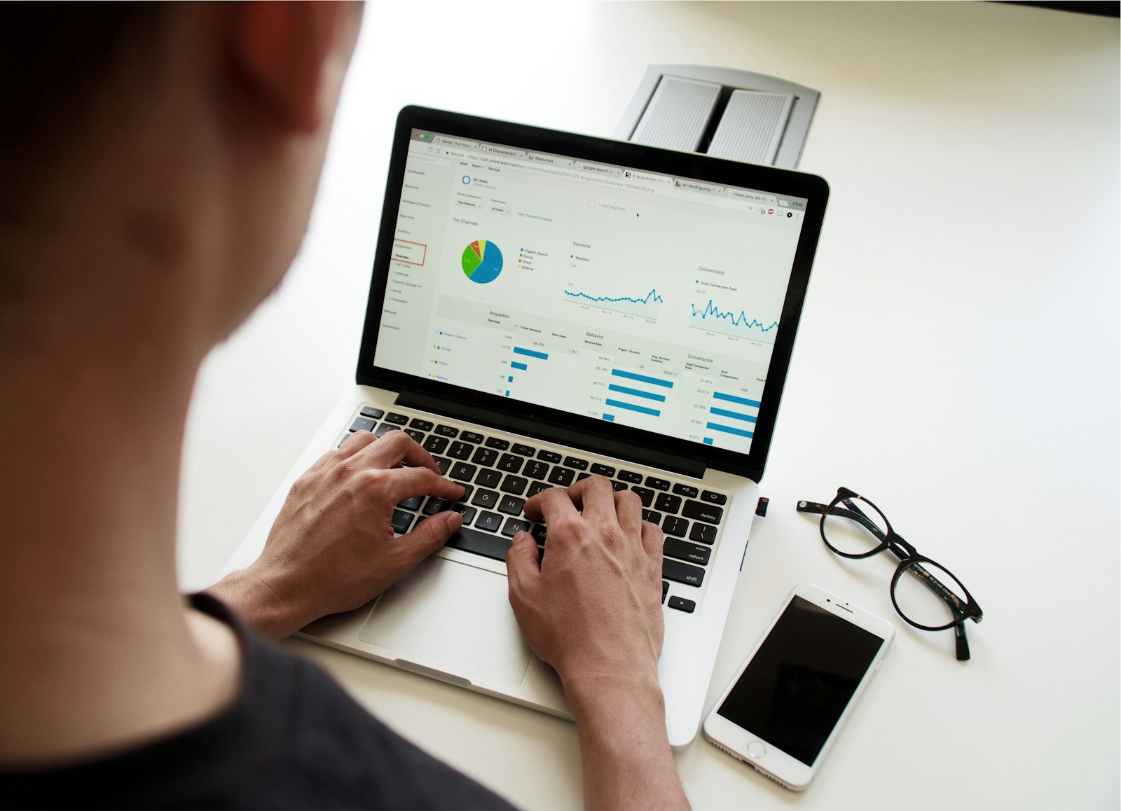 A person working at a laptop, representing calculating the real difference between revenue and profit