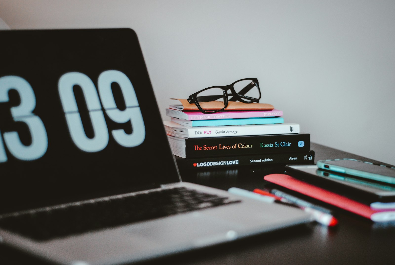 A laptop and books on a desk, representing crafting a standout resume and portfolio