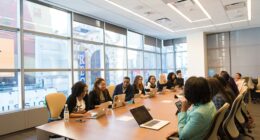 Small group of coworkers sitting together with laptops, representing a new hire's first days onboarding