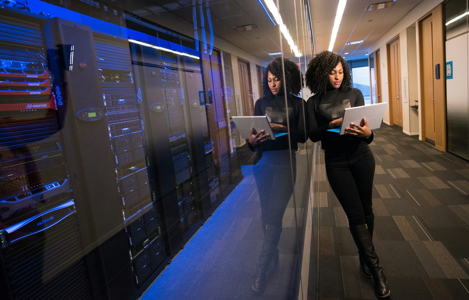 Woman working on a laptop in an office, representing deciding between a generalist or specialist hire