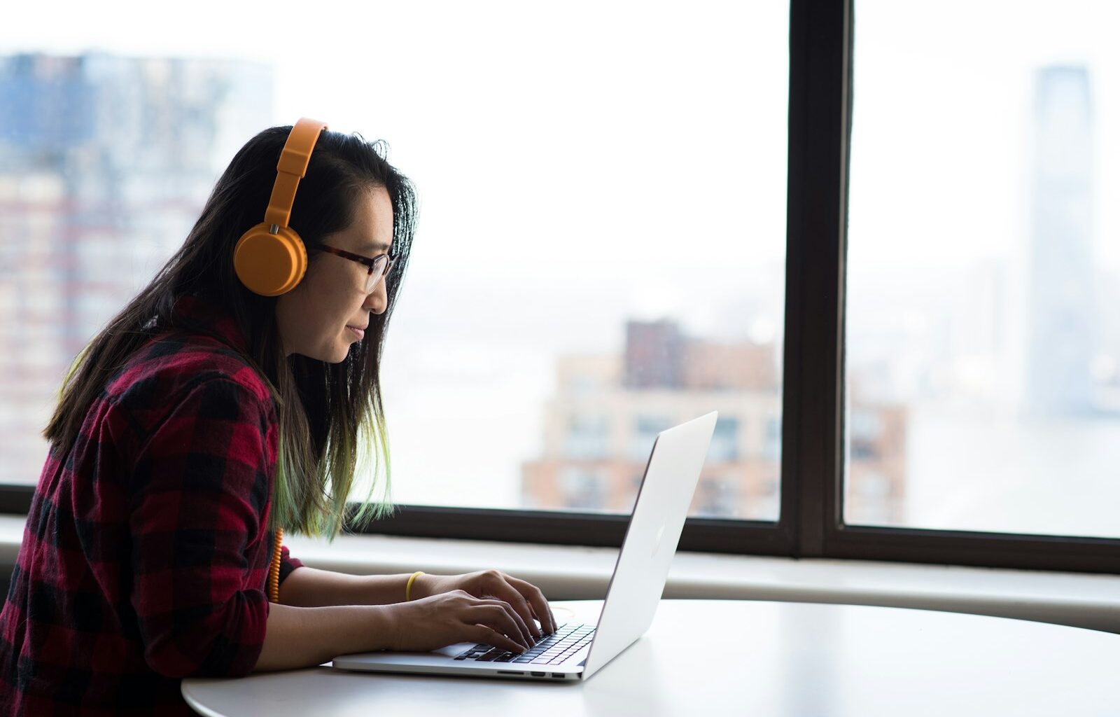 Woman sitting in front of a laptop, representing an employee's last days before leaving