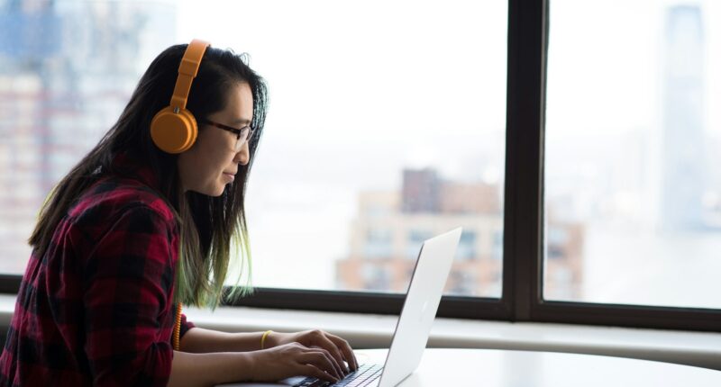 Woman sitting in front of a laptop, representing an employee's last days before leaving