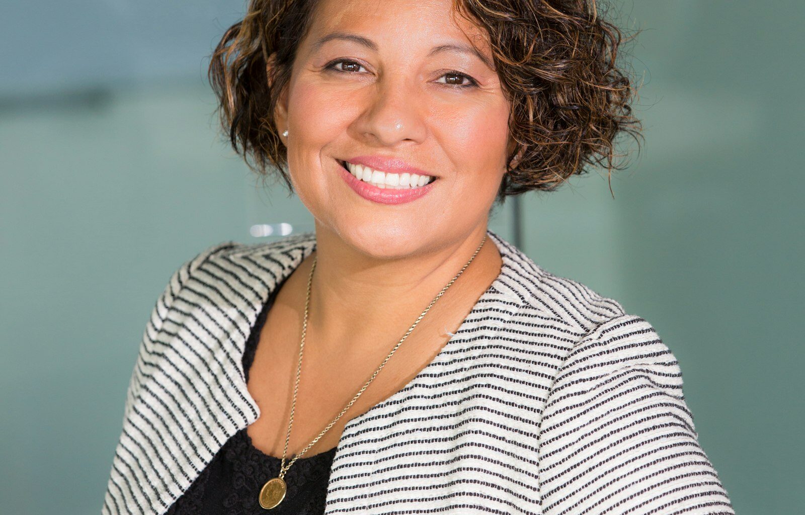 Woman working focused at a desk, representing a founder evaluating their first hire