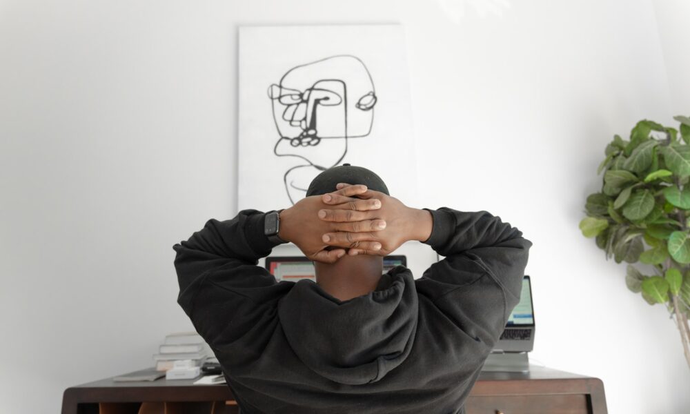 A person sitting thoughtfully, reflecting on career direction and passion versus practicality
