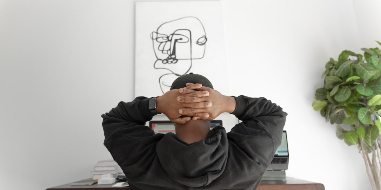 A person sitting thoughtfully, reflecting on career direction and passion versus practicality