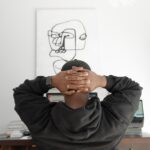 A person sitting thoughtfully, reflecting on career direction and passion versus practicality
