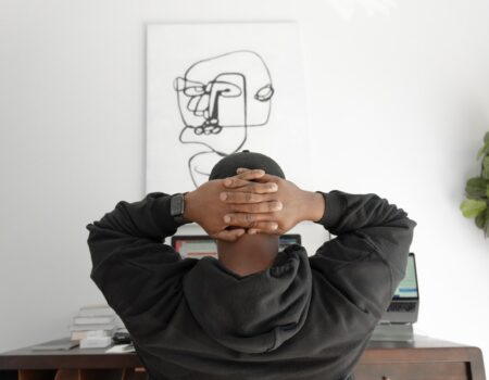 A person sitting thoughtfully, reflecting on career direction and passion versus practicality