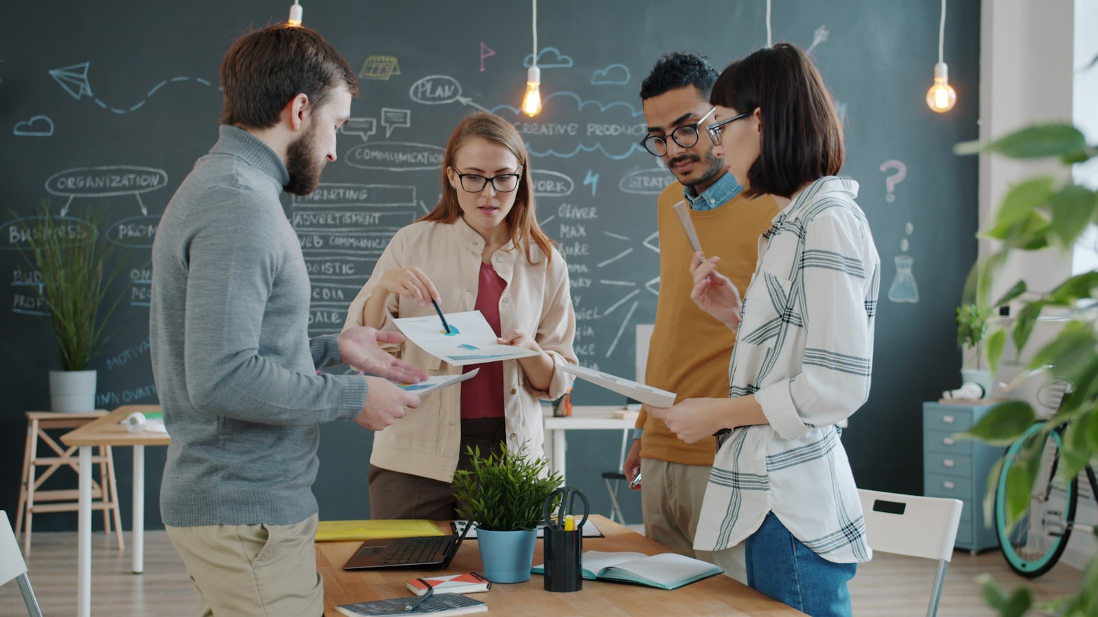A diverse team collaborating on a project in an office, representing choosing between growth and survival priorities