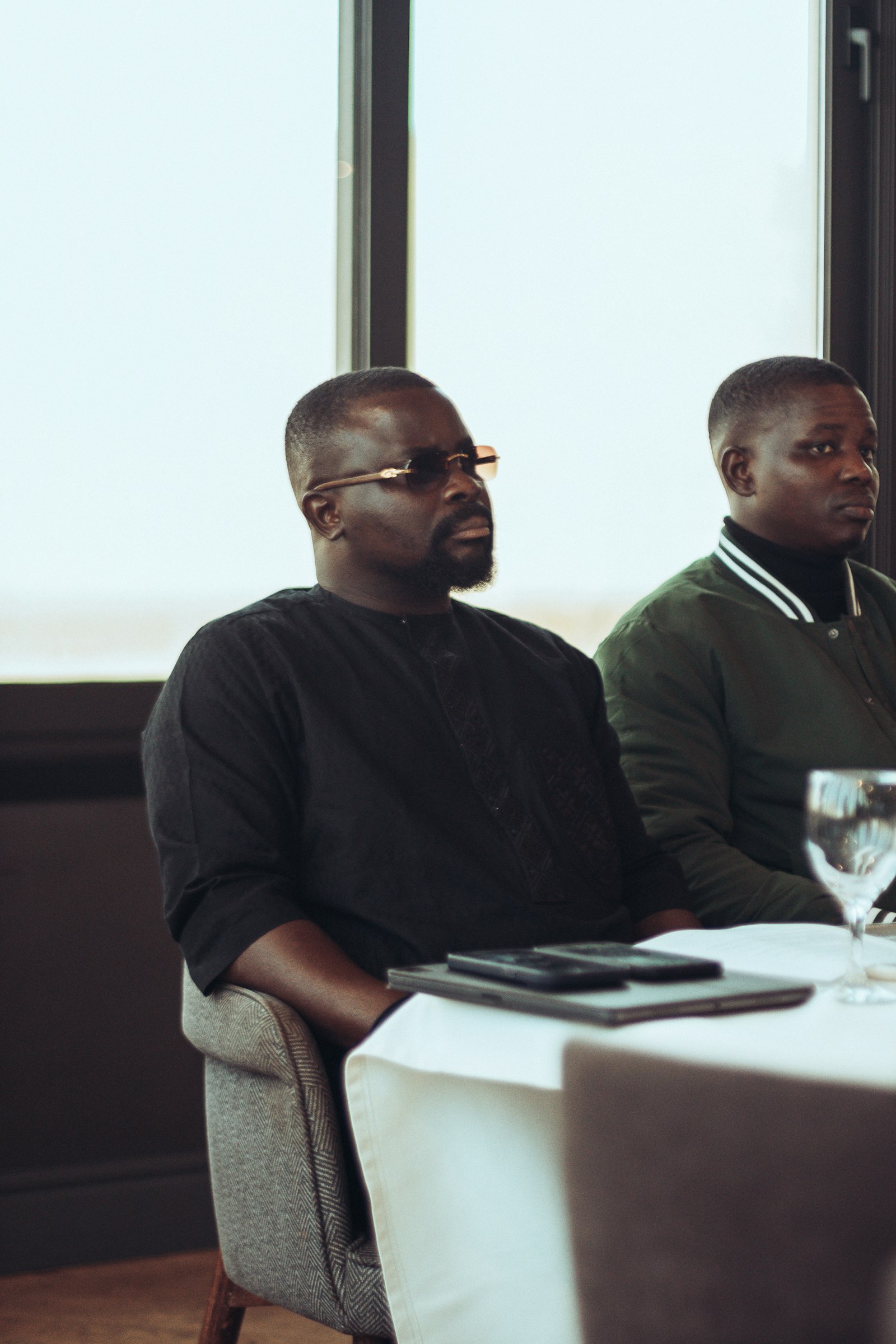 Two people in a serious discussion at a table, representing weighing whether to decline a revenue opportunity